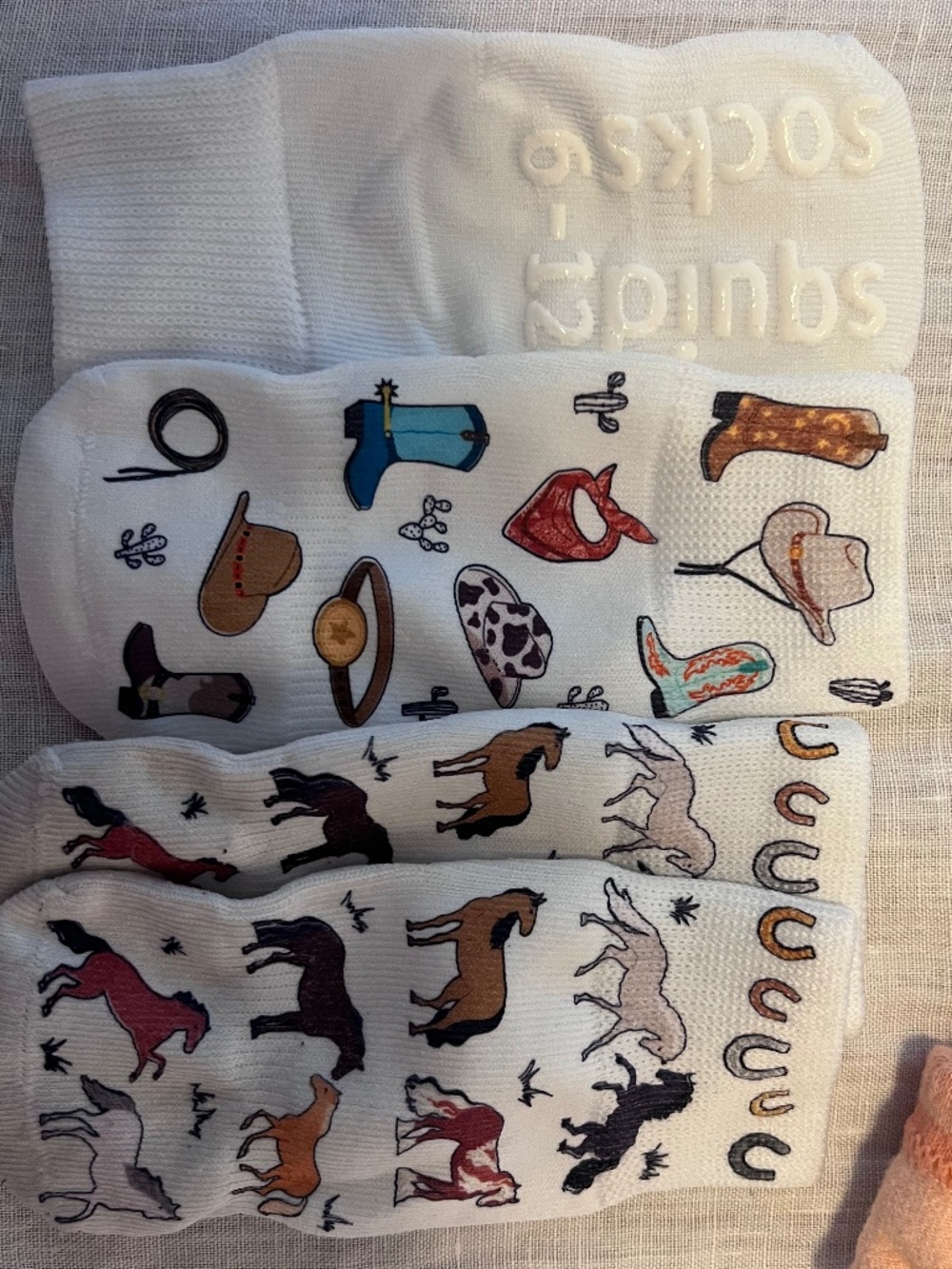 5 squid sock pairs in different styles for 6-12M, and 2 Bombas booties 6-12M